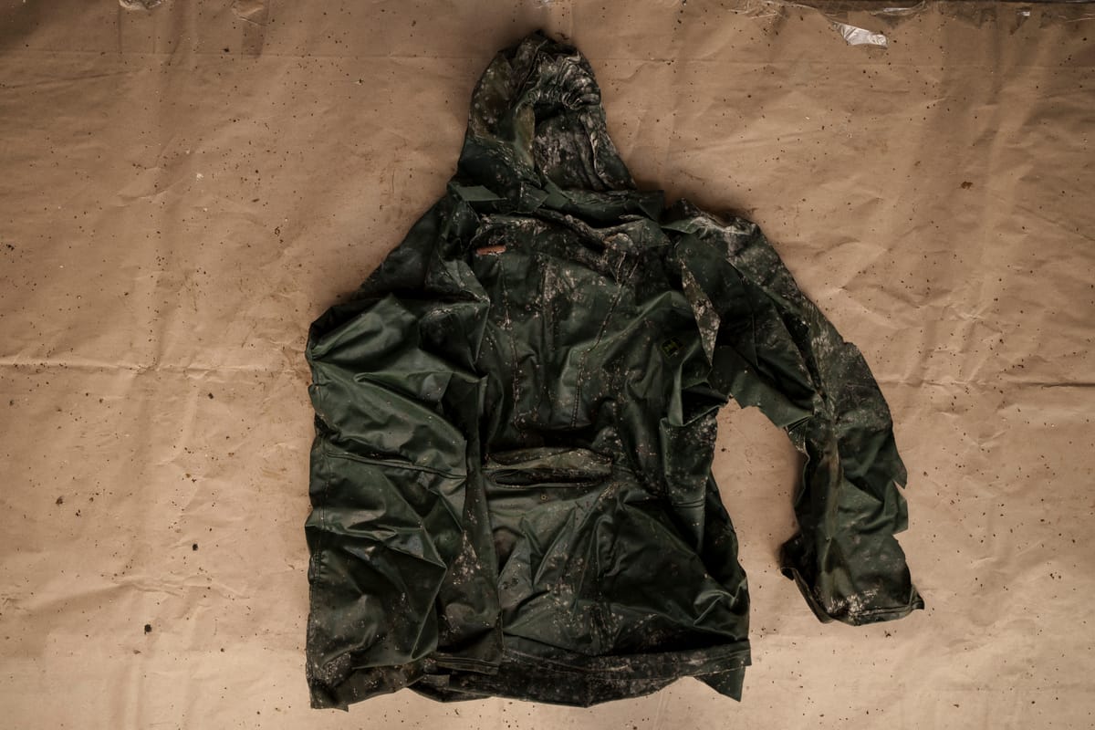A green weatherproof hooded jacket.