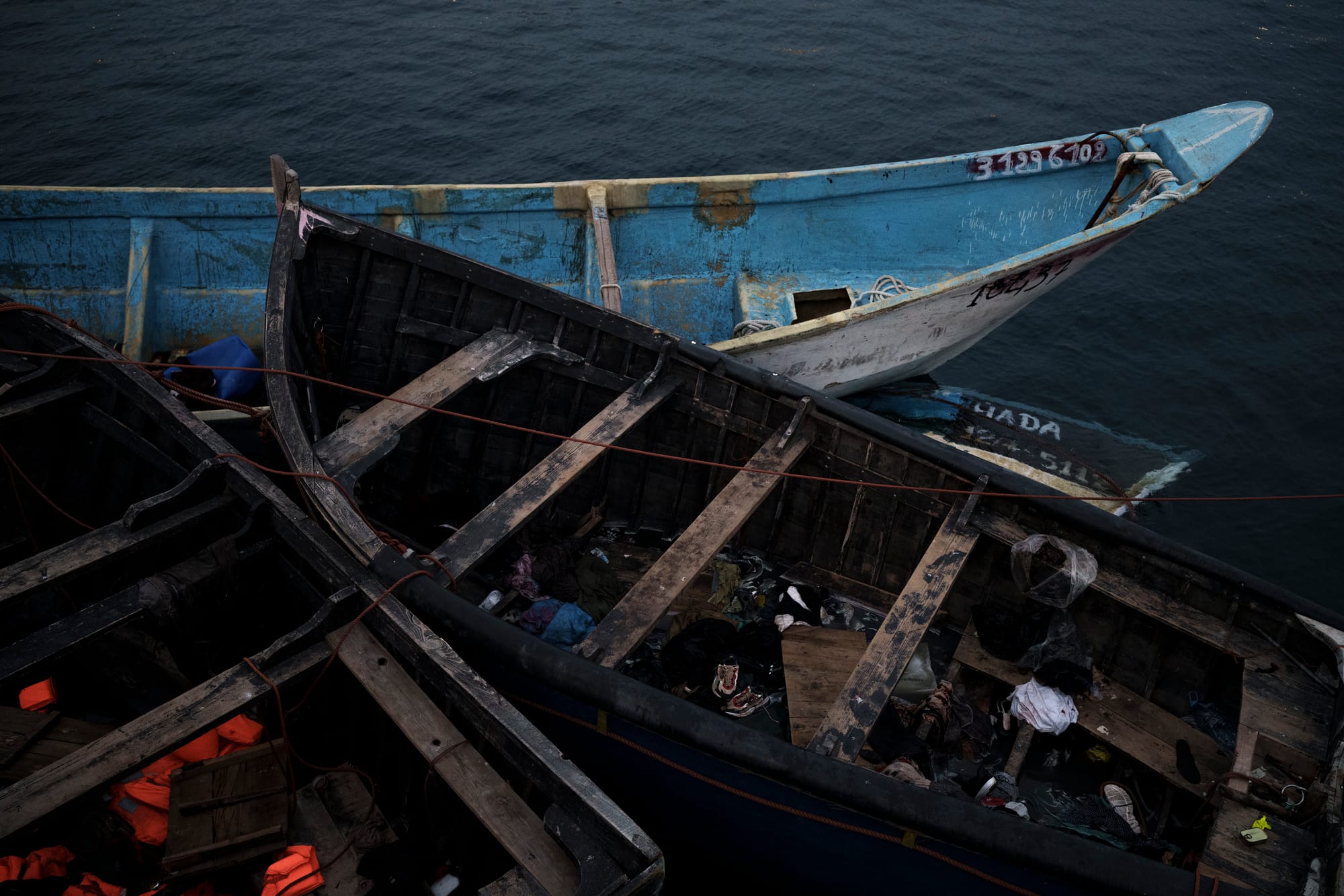 A small pile of weather-beaten boats.