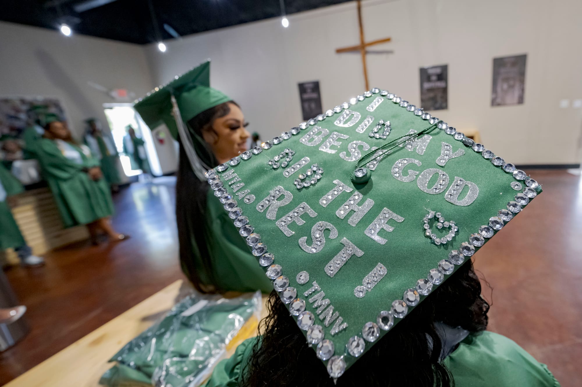 A close-up photo of a green mortarboard bedazzled with the words, “I did my best; God did the rest!”